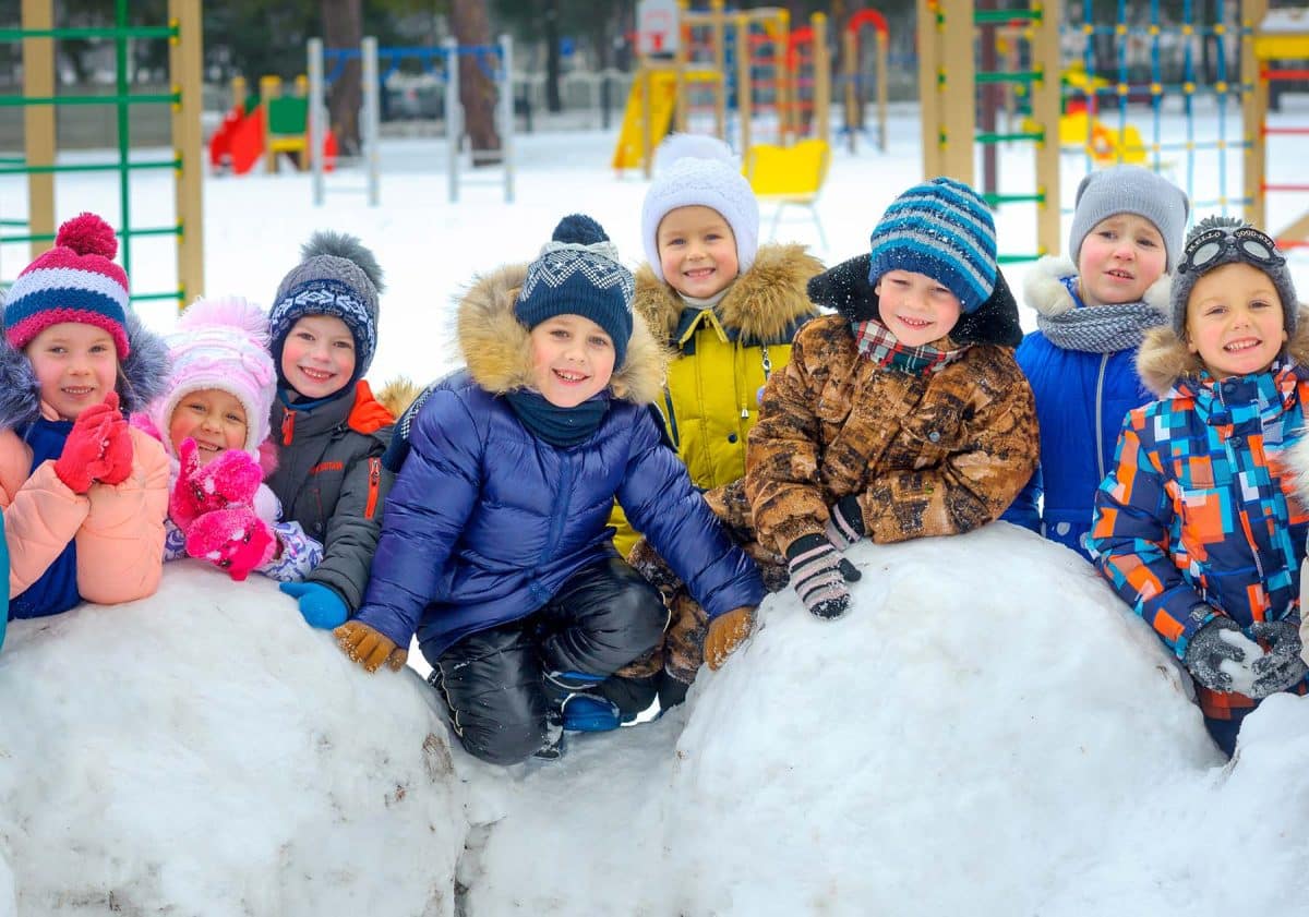 friendly group of children playing at the winter playground